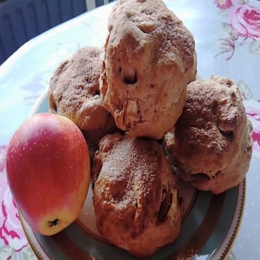 Group of apple and cinnamon scones on a plate with one Worcester apple